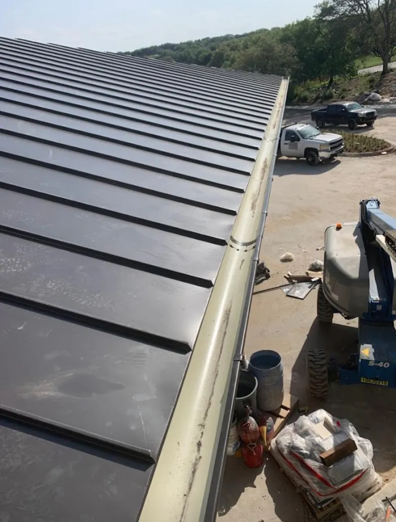 Standing seam panel and gutter detail on a metal roofing jobsite in Dayton